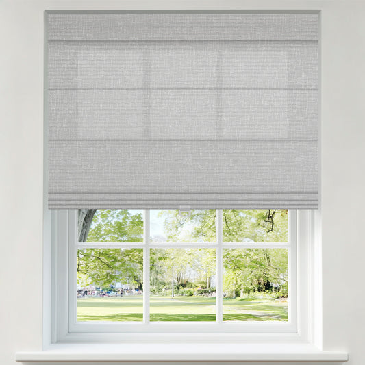 Berissa Top Down Bottom Up Classic Roman Shades in a light gray color covering a window with a view of a green park.