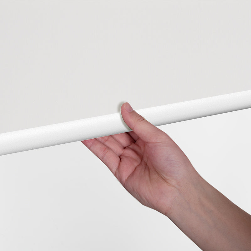 Hand adjusting the Berissa Classic Sunscreen Roller Blind 5% & 10% Openness for optimal light control.