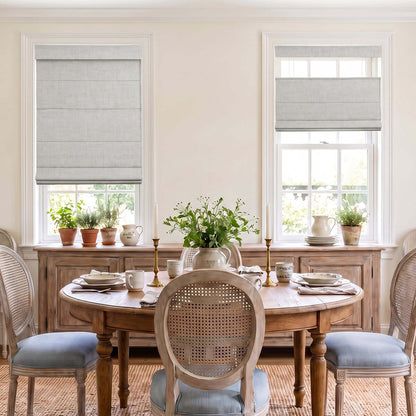 A beautifully set dining room featuring Berissa Charcoal Linen No Tool No Drill TDBU Roman Shades on the windows.