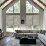 Elegant living room featuring Berissa Full Wrap-around Cassette Valance Roller Shades against large windows.