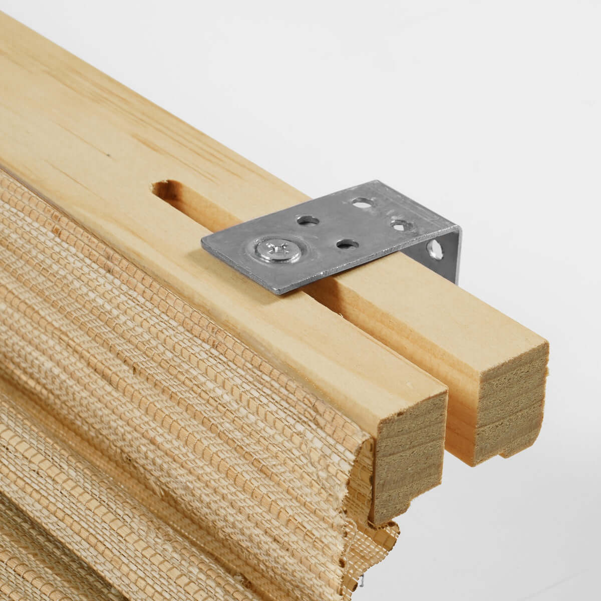 Berissa Natural Soft Glow Woven Bamboo Roman Shade hardware detail with woven bamboo texture.