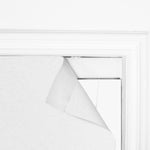 Close-up of Berissa Custom Flat Fold Roman Shade Cordless partially rolled up on a window.