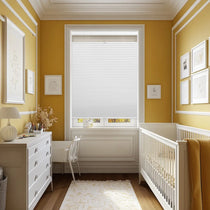 Berissa 1.5 Inch Heat Insulated Top Down Bottom Up Cellular Blinds in a cozy nursery with yellow walls.