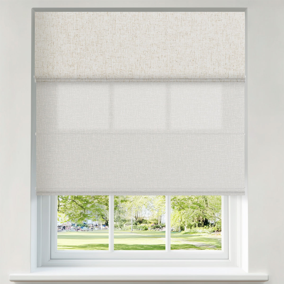 Berissa Custom Blackout and Light Filtering Splicing Motorized Remote Roman Shades in a window.
