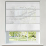 Berissa Custom Flat Fold Roman Shade Cordless installed in a window with a view of lush greenery.
