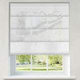 Berissa Custom Flat Fold Roman Shade Cordless installed in a window with a view of lush greenery.