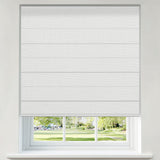 Berissa Pure Soft Waffle Texture Blackout Roman Shade Cordless Child Safe displayed in a bright room overlooking a park.