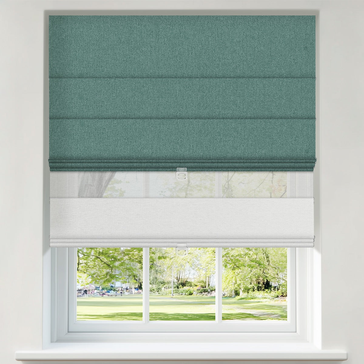 Berissa Vintage Blackout Green No Drill Double Shades Roman Shades styled in a window with a view of greenery.
