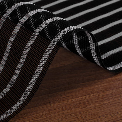 Close-up of Berissa Natural Style Faux Bamboo Roman Shades featuring a black and white striped design.