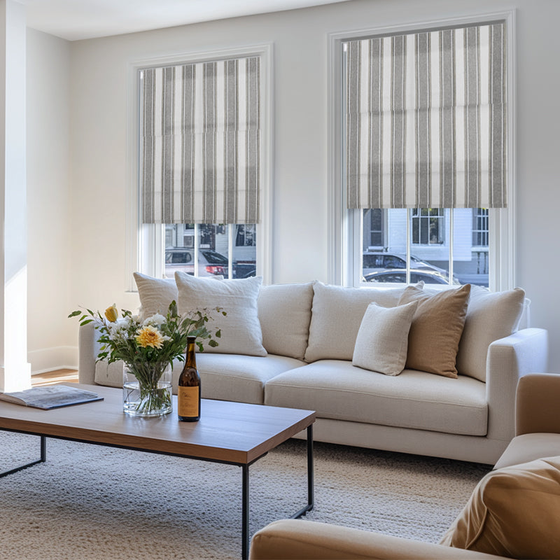 Berissa Candy Square Stripe Custom Roman Shades in a stylish living room with a cozy sofa and coffee table.